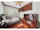 Bedroom featuring wood flooring, ceiling fan, built in desk and shuttered windows at 5229 Brighton Shore Dr, Apollo Beach, FL 33572