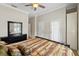 Bedroom featuring a ceiling fan, wood floors, and closet door at 5229 Brighton Shore Dr, Apollo Beach, FL 33572