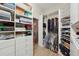Organized walk-in closet featuring built-in shelving, drawers, and ample storage space for clothes and accessories at 5229 Brighton Shore Dr, Apollo Beach, FL 33572