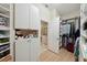 Custom closet featuring shelving, storage cabinets, and hanging rods, providing ample storage, and a doorway to bathroom at 5229 Brighton Shore Dr, Apollo Beach, FL 33572