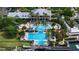 Aerial view of a community pool area with various pools, a waterslide, and lounging space at 5229 Brighton Shore Dr, Apollo Beach, FL 33572