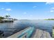 Scenic dock view with a boat lift and a calming waterfront panorama, plus canoe at 5229 Brighton Shore Dr, Apollo Beach, FL 33572