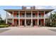 Beautiful two-story building featuring large windows, white pillars, and well-maintained landscaping at 5229 Brighton Shore Dr, Apollo Beach, FL 33572