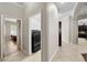 Hallway showing the tile floors and access to the laundry room and kitchen at 5229 Brighton Shore Dr, Apollo Beach, FL 33572