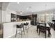 Modern kitchen with stainless steel appliances, bar seating, and an adjacent dining area at 5229 Brighton Shore Dr, Apollo Beach, FL 33572