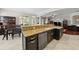 Open kitchen design with granite counters, stainless steel appliances, and a breakfast bar overlooking the living space at 5229 Brighton Shore Dr, Apollo Beach, FL 33572