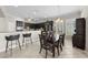 Well-appointed kitchen featuring dark cabinetry, a breakfast bar, and a dining area with natural light at 5229 Brighton Shore Dr, Apollo Beach, FL 33572