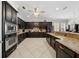 Well-equipped kitchen with dark cabinetry, granite countertops, tile backsplash, and stainless steel appliances at 5229 Brighton Shore Dr, Apollo Beach, FL 33572