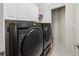 Laundry room featuring a Samsung washer and dryer with white cabinets above at 5229 Brighton Shore Dr, Apollo Beach, FL 33572