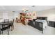 Open-concept living room with neutral carpet, bar area, bedroom area, and dining area at 5229 Brighton Shore Dr, Apollo Beach, FL 33572
