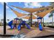 Well-equipped community playground with slides and play structures under shaded canopies at 5229 Brighton Shore Dr, Apollo Beach, FL 33572