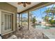 A covered patio area with a beautiful pool and a spa that overlooks the water at 5229 Brighton Shore Dr, Apollo Beach, FL 33572