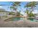 A screened pool and spa with lush landscaping and waterfront views at 5229 Brighton Shore Dr, Apollo Beach, FL 33572