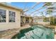 A screened pool and spa with lush landscaping and waterfront views at 5229 Brighton Shore Dr, Apollo Beach, FL 33572