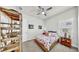 Cozy bedroom featuring a floral-themed bed, ceiling fan, and ample natural light from the window at 5317 Del Coronado Dr, Apollo Beach, FL 33572