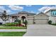 Beautiful home featuring a three-car garage and stone accents on the facade at 5317 Del Coronado Dr, Apollo Beach, FL 33572