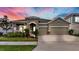 Charming single Gathering home with a well manicured lawn, stone facade, and 2 car garage at 5317 Del Coronado Dr, Apollo Beach, FL 33572