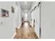 Hallway featuring wood floors, white walls, and sliding barn doors at 5317 Del Coronado Dr, Apollo Beach, FL 33572