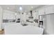 Bright kitchen featuring a large island with stainless appliances and modern lighting at 5317 Del Coronado Dr, Apollo Beach, FL 33572