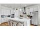 Modern kitchen with white cabinets, stainless steel appliances, a center island and pendant lighting at 5317 Del Coronado Dr, Apollo Beach, FL 33572
