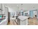 Modern kitchen boasts an oversized island with pendant lights, stainless steel appliances, and an open floorplan at 5317 Del Coronado Dr, Apollo Beach, FL 33572