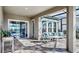 Covered lanai featuring brick floors, ceiling fan, sliding glass door to the pool at 5317 Del Coronado Dr, Apollo Beach, FL 33572