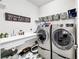 Well-organized laundry room featuring a utility sink, modern washer and dryer, and stylish tile flooring at 5317 Del Coronado Dr, Apollo Beach, FL 33572