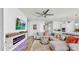 Bright living room with a modern fireplace, comfortable seating, and a ceiling fan at 5317 Del Coronado Dr, Apollo Beach, FL 33572