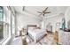 Beautiful main bedroom featuring tray ceiling, ceiling fan, and light wood grain furniture at 5317 Del Coronado Dr, Apollo Beach, FL 33572