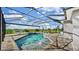 A beautiful in-ground pool inside an enclosed pool cage with chairs and a spa at 5317 Del Coronado Dr, Apollo Beach, FL 33572