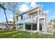 Charming raised beach house with light blue siding, white trim, and outdoor staircase at 6841 Oelsner St, New Port Richey, FL 34652