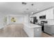 Bright open concept kitchen featuring a large island with pendant lighting and stainless appliances at 6841 Oelsner St, New Port Richey, FL 34652