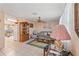 Cozy living room featuring tile flooring, a ceiling fan, and neutral paint at 6906 Sandalwood Dr, Port Richey, FL 34668