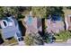 Aerial view of a house with a screened pool, showcasing its roofline and surrounding neighborhood trees at 8600 Berkley Dr, Hudson, FL 34667