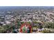 Aerial view of the property showcasing a pool and surrounded by mature trees in a residential neighborhood at 8600 Berkley Dr, Hudson, FL 34667