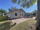 View of backyard featuring a paved patio, a screened in pool area, and lawn at 8600 Berkley Dr, Hudson, FL 34667