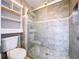 Modern bathroom with a glass enclosed tiled shower and white shelves at 8600 Berkley Dr, Hudson, FL 34667