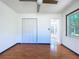 Bedroom with wood-look floors and a bifold closet door, offering ample storage at 8600 Berkley Dr, Hudson, FL 34667