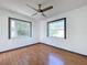 Cozy bedroom featuring wood-look flooring and two windows with great light at 8600 Berkley Dr, Hudson, FL 34667