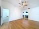 Bright bedroom with hardwood floors, fan, and an attached bathroom at 8600 Berkley Dr, Hudson, FL 34667