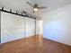 Bedroom with wood-look floors and a sliding barn door closet with track hardware at 8600 Berkley Dr, Hudson, FL 34667