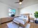 Stylish bedroom with a modern bed, dresser, and a large window, creating a relaxing atmosphere at 8600 Berkley Dr, Hudson, FL 34667