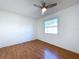 Bedroom featuring wood-look flooring, a ceiling fan and a large window at 8600 Berkley Dr, Hudson, FL 34667