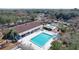 Community pool with an adjacent covered structure and tennis courts in a wooded, residential neighborhood at 8600 Berkley Dr, Hudson, FL 34667