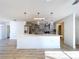 A stylish updated kitchen features pendant lighting, an island, stainless appliances, and stone backsplash at 8600 Berkley Dr, Hudson, FL 34667