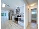 This updated kitchen features stainless steel appliances, stone backsplash, modern cabinetry, and barstool seating at 8600 Berkley Dr, Hudson, FL 34667