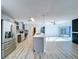Open concept living space features an updated kitchen with stainless appliances and an island with pendant lighting at 8600 Berkley Dr, Hudson, FL 34667