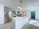 Modern kitchen with stainless appliances, central island, and opens to entry hall and dining or living areas at 8600 Berkley Dr, Hudson, FL 34667