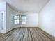 Bright living room featuring a wall of windows and stylish wood-look flooring at 8600 Berkley Dr, Hudson, FL 34667