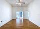 Empty living room featuring hardwood floors and access to a screened-in lanai at 8600 Berkley Dr, Hudson, FL 34667
